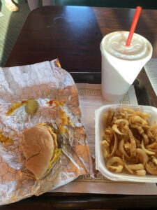 Double cheeseburger, fries and fountain drink.